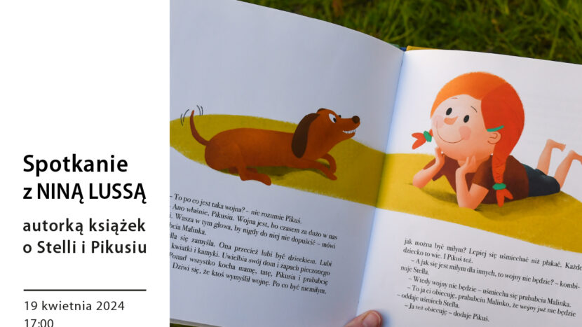 Obrazek do wydarzenia przedstawia fotografię: na tle zielonego trawnika ręka trzymająca otwartą książkę, w niej ilustracja rudowłosej uśmiechniętej dziewczynki i jamnika.