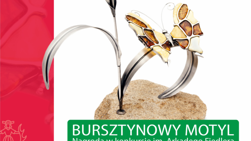 Obrazek do wydarzenia. Na białym tle widnieje statuetka Bursztynowego Motyla. Z kamiennej podstawy wyrasta srebrny liść , na którym umieszczony jest motyl wykonany z bursztynu.